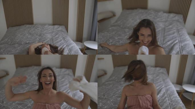 快乐的年轻女子在早上洗完澡后拍摄自拍视频