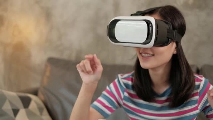 带VR耳机的亚洲女人，观看3D虚拟仿真。