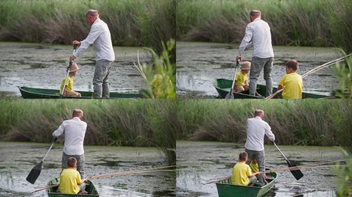 钓鱼，祖父和他的孙子在乡下的户外活动中乘船从岸上航行