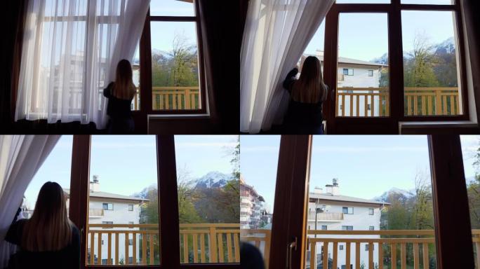 女孩将窗帘从窗户推开，窗外可见凉爽的山景。摄像机移动到窗口