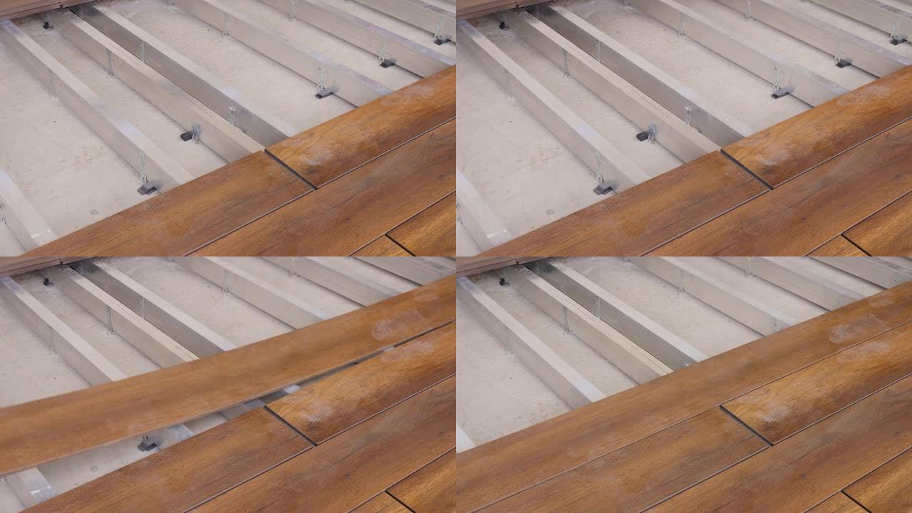 地板安装工程建筑家居装修建筑木质甲板木板木地板覆盖物。修理木板连接的家庭甲板地板。木匠设置甲板地板木