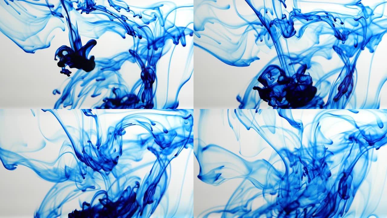 蓝色墨水滴入水中，溶解在白色背景上，慢动作。