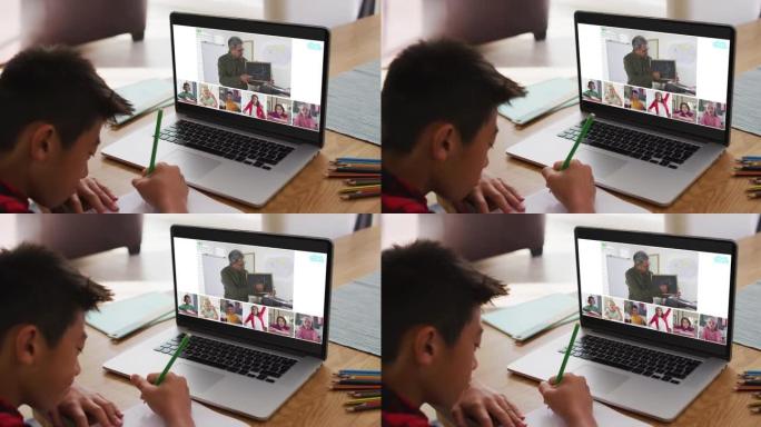 亚洲男孩在家做作业并与老师和同学在笔记本电脑上进行视频会议
