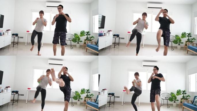 年轻的亚洲健身夫妇在客厅拳击武术
