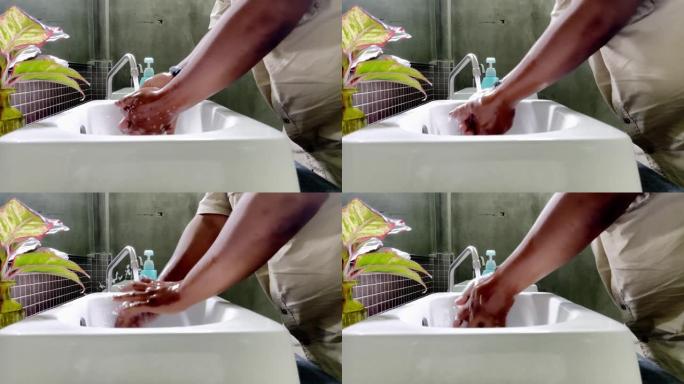 一个大男人在水槽前洗手，以防止在致命的疫情中新型冠状病毒肺炎冠状病毒。