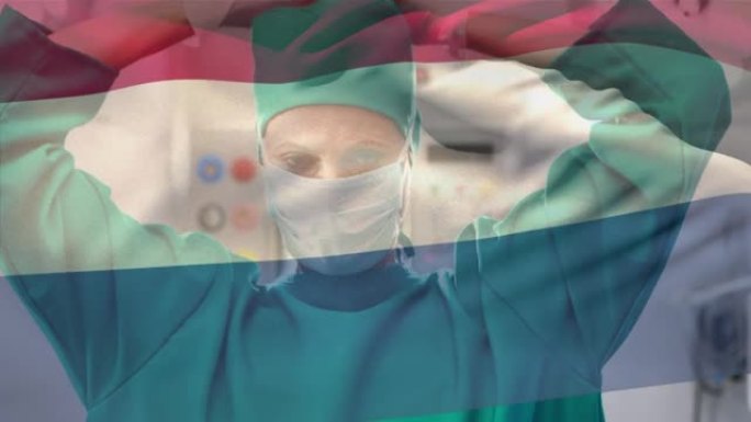 荷兰国旗在医院挥舞着戴着口罩的高加索女外科医生