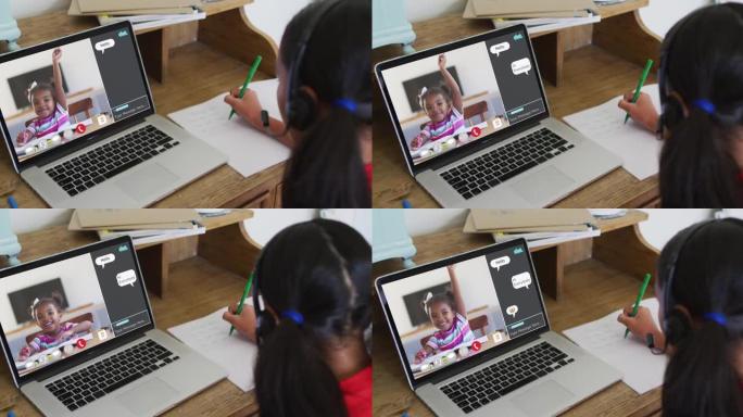 女学生在家中使用笔记本电脑进行在线课程，女孩举手并在屏幕上进行网络聊天
