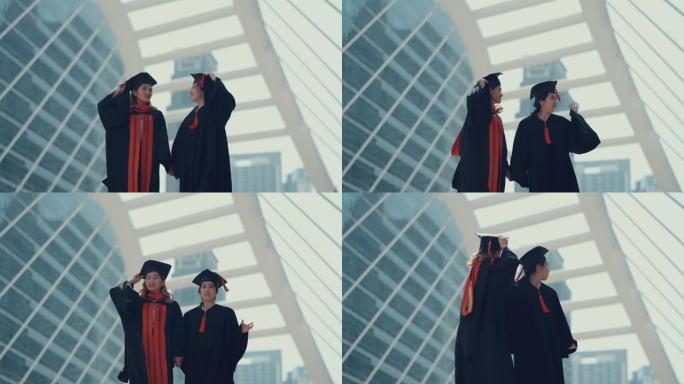 两个美丽的女人在城市庆祝毕业。