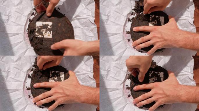 舒普饼中国发酵红茶白纸刀。男性手握碎碎压旧圆形成熟深色普洱成片健康健神饮料咖啡替代品4K