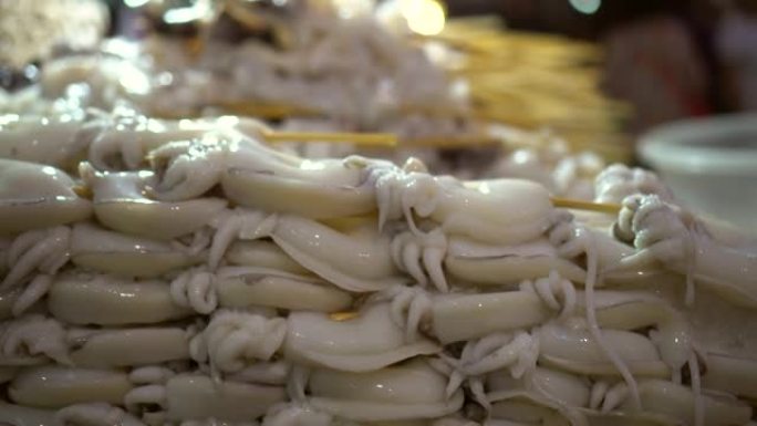 一堆腌制的墨鱼串在曼谷中国城著名海鲜店等待烧烤