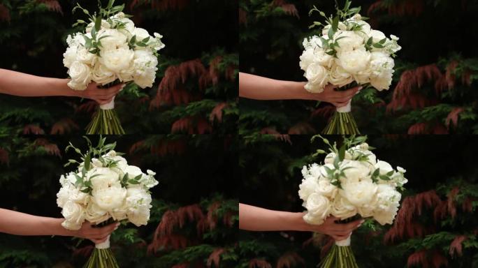 牡丹和玫瑰的白色新娘花束。婚礼的风景。