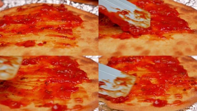 在厨房里，用塑料刮刀将番茄酱涂在披萨面团上的女性双手关闭。自制披萨的过程。