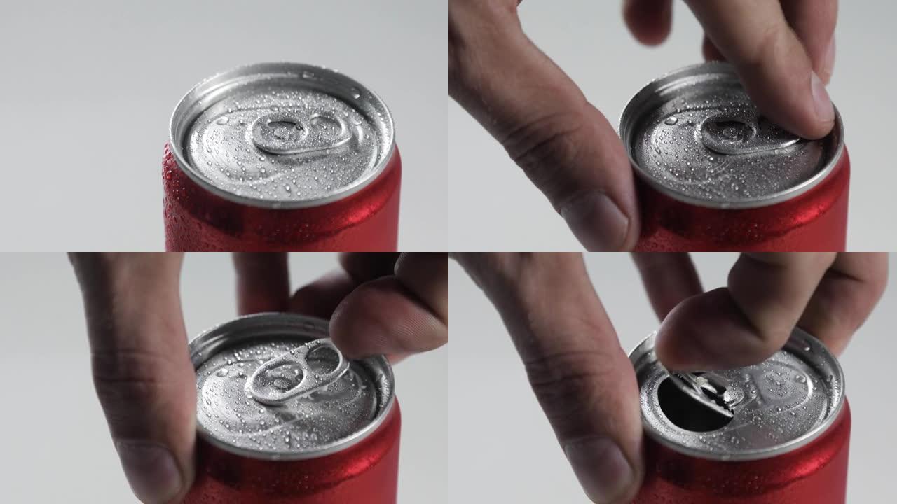 男性手打开一罐可乐。特写