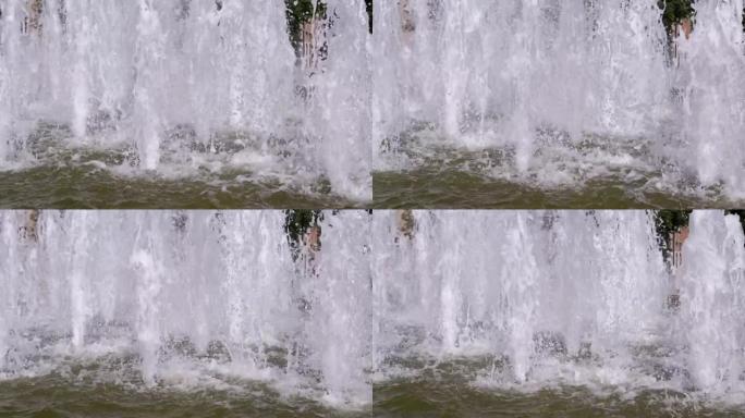 水柱、水滴、飞溅落在城市喷泉里。慢动作