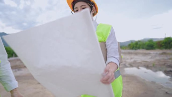 年轻的女工程师项目员工看结构蓝图纸，结构规划师房地产工人，安全第一，户外建筑工地，制造，独立努力工人