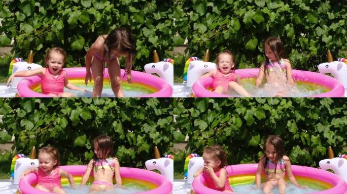 在夏日，女孩们一起在院子里的一个小充气游泳池里跳得很开心。