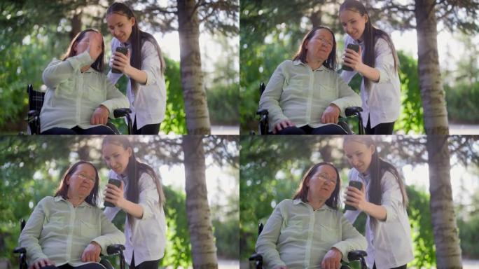 专业女性医护人员通过智能手机视频通话帮助轮椅上的老年女性