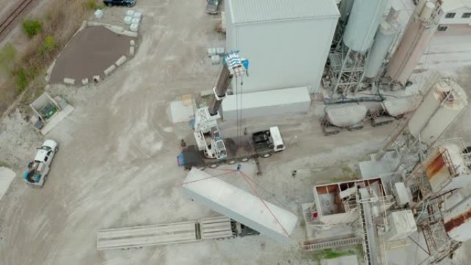 起重机的空中无人机视图在工厂卸下了承运人的卡车。宽幅以上