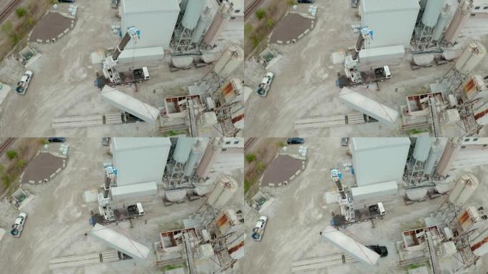 起重机的空中无人机视图在工厂卸下了承运人的卡车。宽幅以上