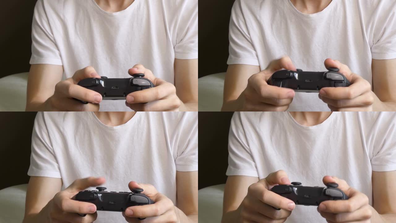 无法识别的年轻人玩电子游戏，手里拿着控制器