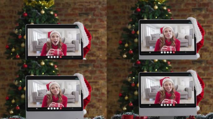 快乐的白人妇女在计算机上进行视频通话，带有圣诞节装饰品和树木