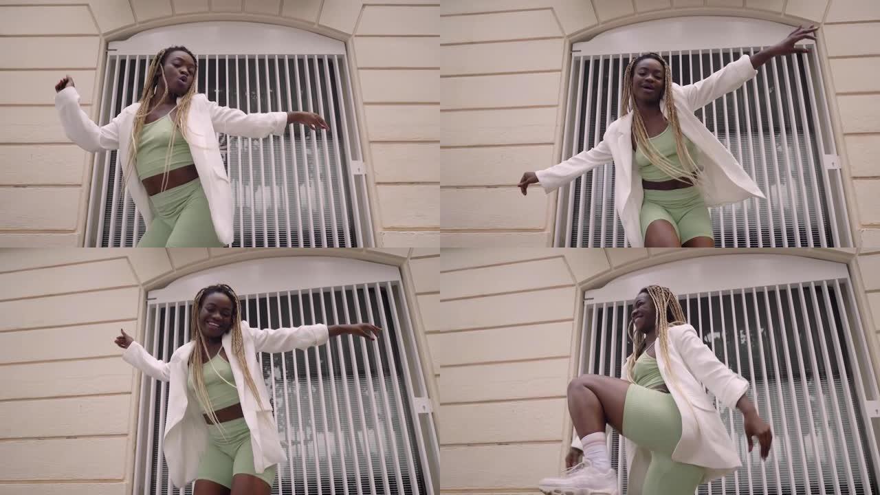 活跃的城市非裔美国女性在白色墙壁背景下跳舞。酷炫的有才华的女舞者对嘻哈音乐节奏有节奏的自由动作