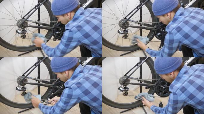 用蓝色超细纤维布清洁自行车链条。定期的普通自行车维护。机械师在自行车车间用布清洁自行车链条