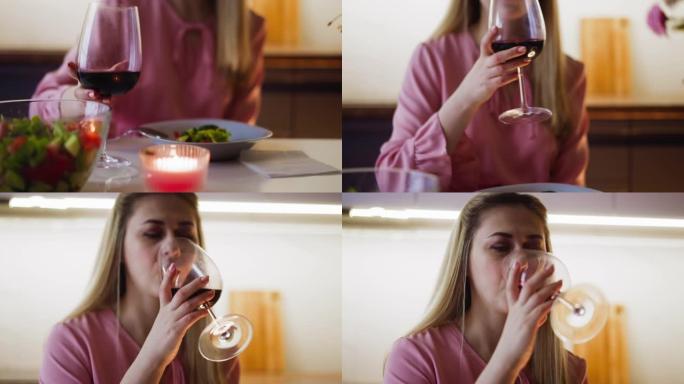 吃沙拉的女人坐在餐桌上喝美味的酒