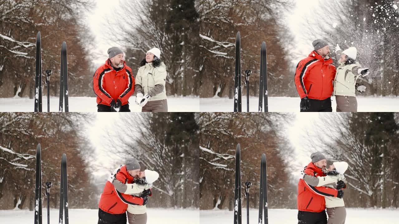 滑雪者配偶在冬季森林里扔雪