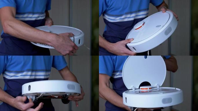 男性手里拿着一个新购买的自动机器人真空吸尘器。4K.特写