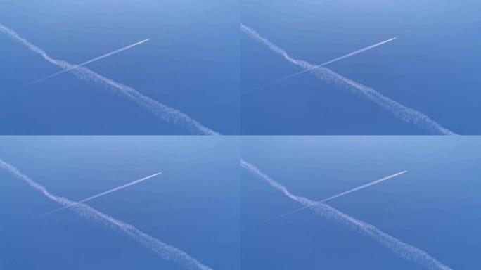 在蓝天上对角线飞行的商用飞机进入框架。飞机航空机场将云雾笼罩。白色客机在蓝天中拉动白色凝结尾迹时运送