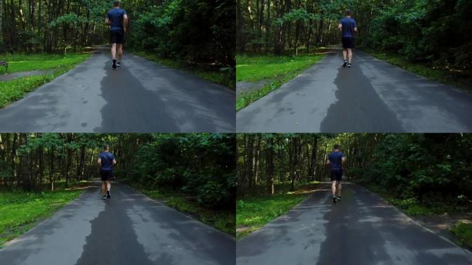 一名男子运动员在公园户外跑步，在森林周围，橡树绿草，年轻持久的运动运动员跑运动健身步道腿马拉松，慢跑
