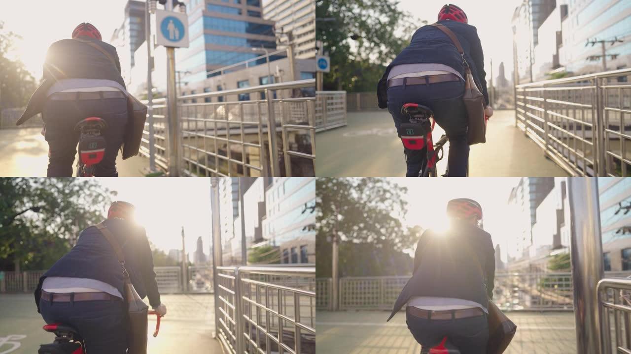 年轻活跃的商人早上骑自行车去大城市工作，在城市立交桥上骑自行车，以避免高峰时间和人群中的交通不畅，保