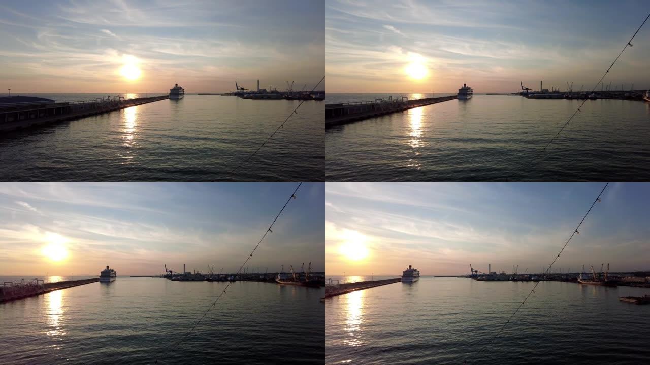 船上梦幻般的日落，港口设施、船只和游轮的天际线