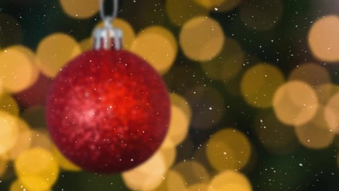 雪花落在红色圣诞节摆设和发光斑点装饰上的动画