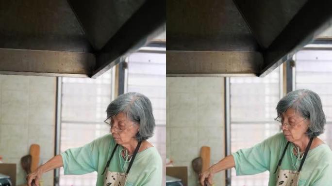亚洲资深女性在家厨房做饭