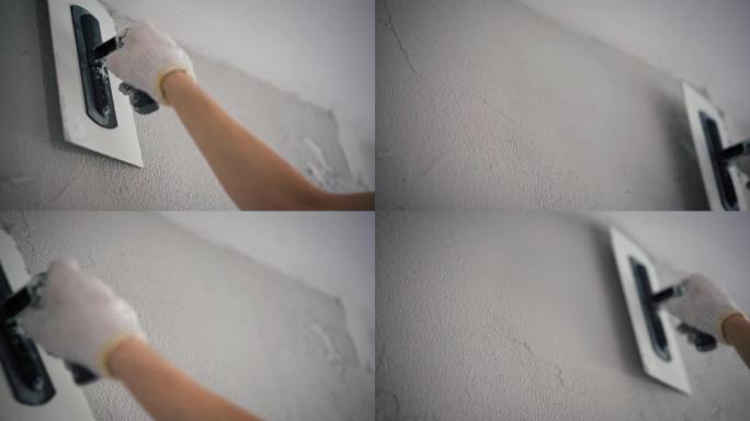 专业修理工用油灰刀修墙的特写镜头