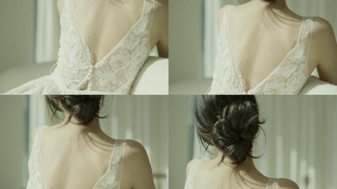 穿着白色连衣裙的美丽亚洲新娘坐在落式窗前的沙发上，以慢动作拍摄