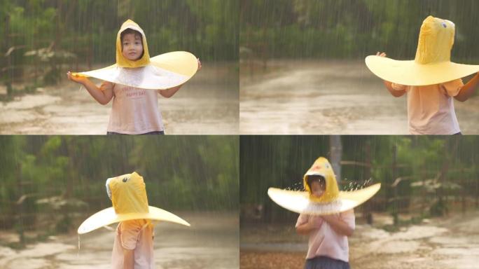 亚洲小女孩在雨中玩水。