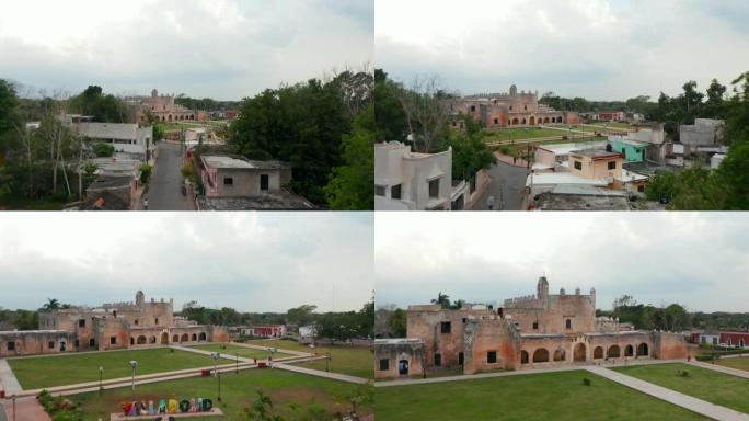 向前飞过镇上的街道。揭示圣贝纳迪诺·德锡耶纳修道院的公园和旧砖砌建筑。历史地标。墨西哥巴利亚多利德