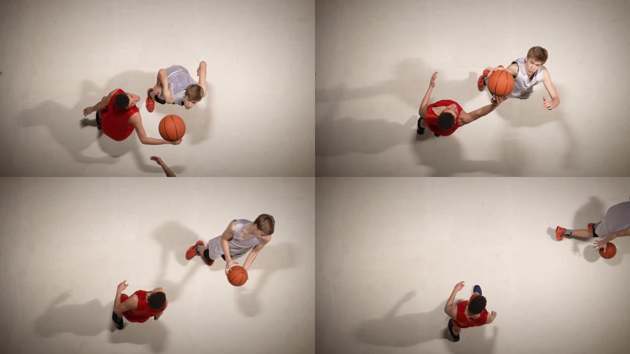 篮球比赛开始前掷界外球的俯视图。两名对方球员为控球而跳跃。慢动作