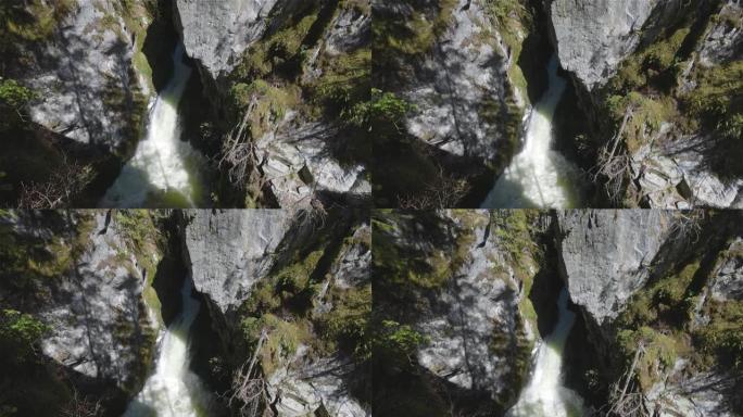 瀑布冲下加拿大山区的一个岩石峡谷。