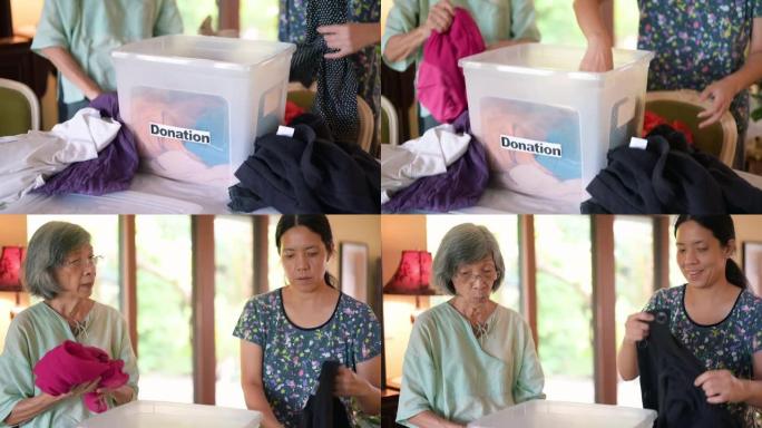 亚洲家庭用捐款箱准备捐赠衣物