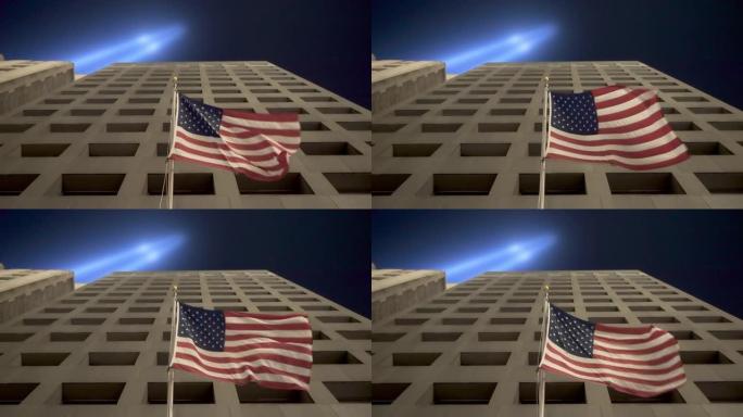 在9月11日纪念灯光下在纽约市的建筑物上挥舞着美国国旗