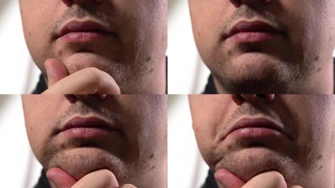 一个男人刮胡子前的脸。下巴上的胡茬