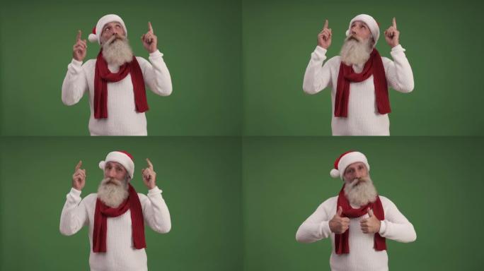 戴着圣诞老人帽子的英俊老人展示了复制空间，并竖起了大拇指。绿色背景。一个人。