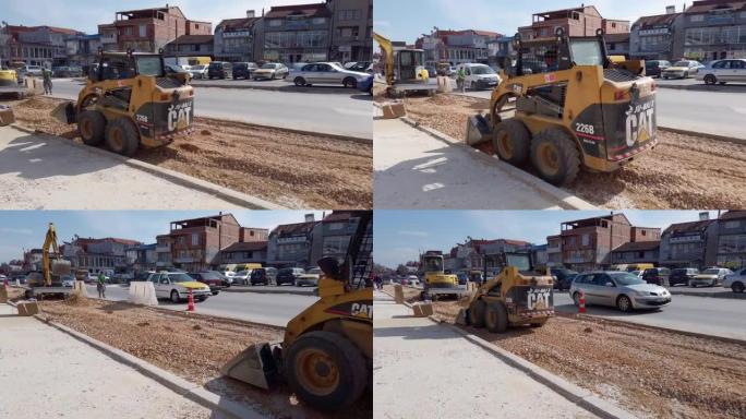 挖掘机在街道上工作，修建一条额外的车道。斯科普里的道路扩建。
