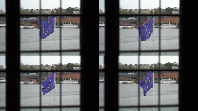 欧盟的旗帜从笼子里缓缓升起。监狱的概念
