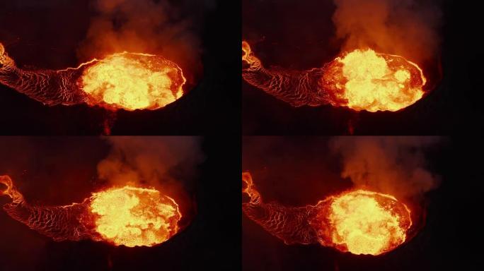活火山火山口热岩浆喷发的高角度视图。沸腾的熔融物质流出。法格拉达尔斯福杰尔火山。冰岛，2021