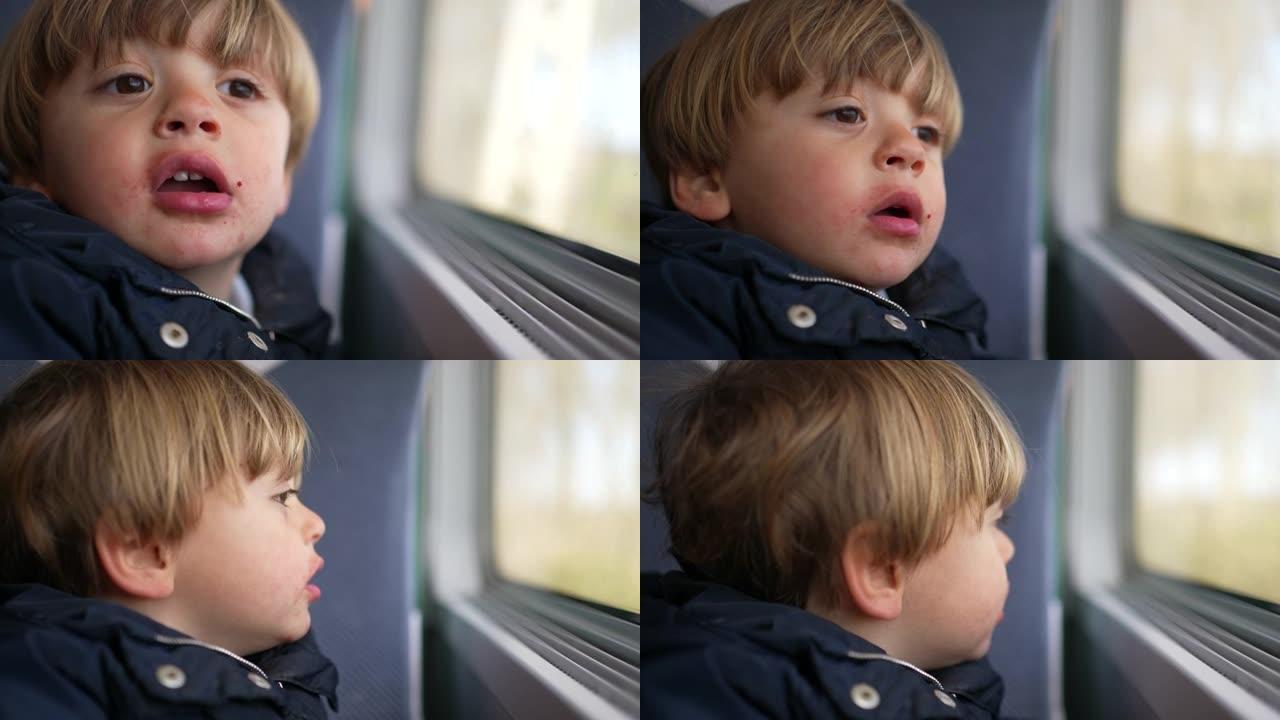 沉思的小男孩在旅途中看着火车窗外，看到乡村经过